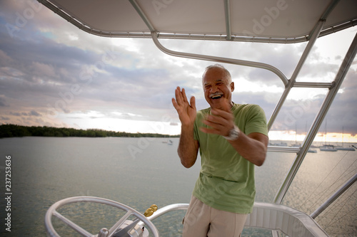 man laughing on boat