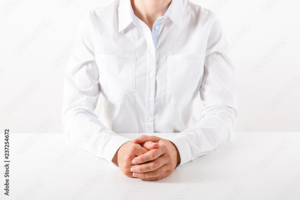 Fototapeta premium Business woman in white sitting at a desk.