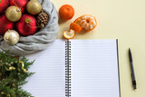 2019 goals. To do list in notepad next to Christmas decorations, cones and tangerines. Planning concept, New year, Christmas, wishes and dreams, festive mood.