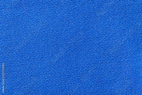 The linen cloth in blue color. Fabric background texture. Detail of textile material close-up