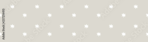 Pretty horizontal seamless border of hand drawn white stars on a warm grey, neutral background. Great for packaging, ribbons, trimmings, scrapbook elements, washi tape and other decorative edgings.