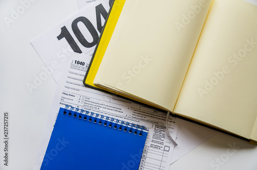 tax form 1040 and notebooks