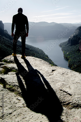 shaddow of man on top of mountain
