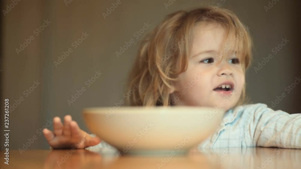 No food. Cute child has no appetite. Kid Boy In Front of a Meal No Appetite does not want to eat healthy homemade food. Boy with unhappy face between mother want to having food for lunch, picky eater No food. Cute child has no appetite. Kid Boy In Front of a Meal No Appetite does not want to eat healthy homemade food. Boy with unhappy face between mother want to having food for lunch, picky eater