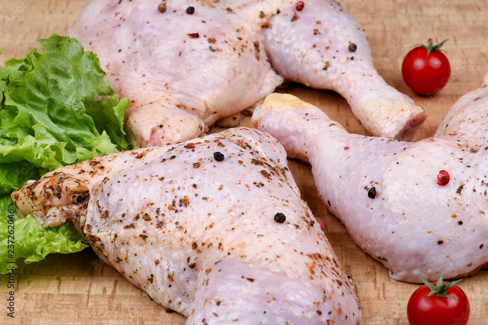A flavored raw chicken thigh on the table before preying top view. A flavored raw chicken thigh on the table before preying top view.