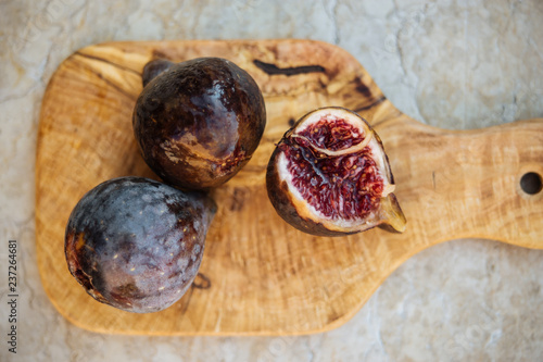 Ripe figs on olive tree board
