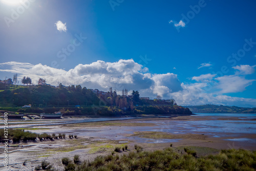 Outdoor view of huge ship in the mud after low tide in CastroChilean mainland photo