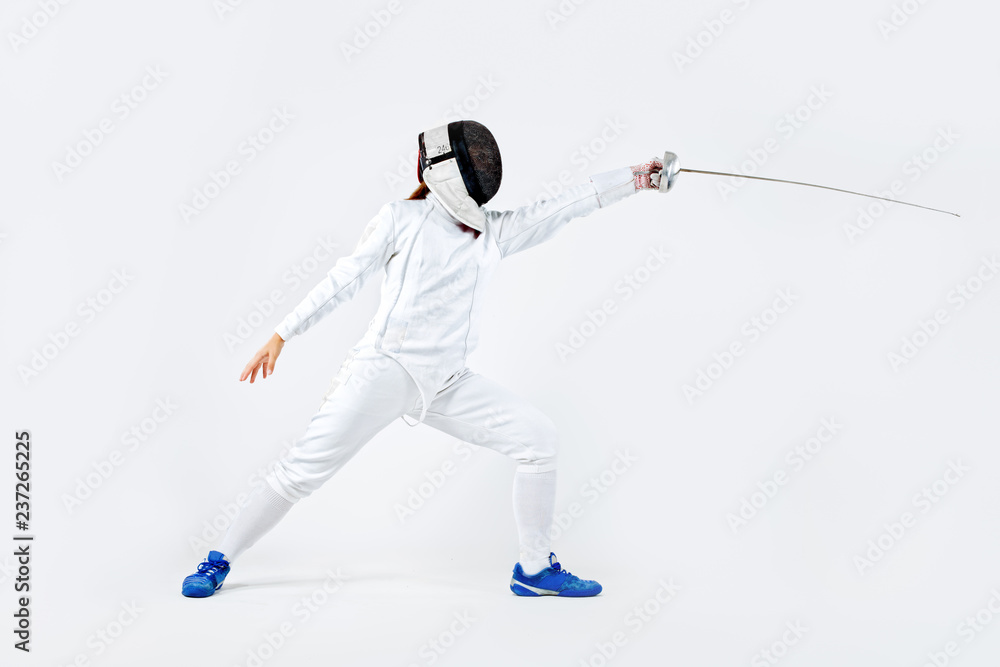 Young fencer athlete wearing mask and white fencing costume. holding the sword. Isolated on white background Young fencer athlete wearing mask and white fencing costume. holding the sword. Isolated on white background