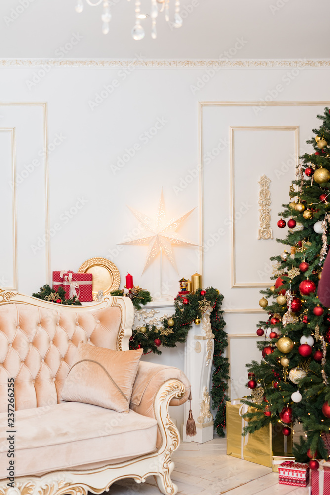 New Year's decor in the room with a Christmas tree, a fireplace and gifts New Year's decor in the room with a Christmas tree, a fireplace and gifts