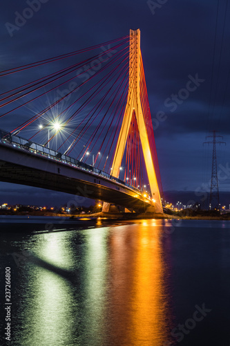 Illuminated cable stayed bridge over Martwa Wisla river at night in Gdansk. Poland Europe © vivoo