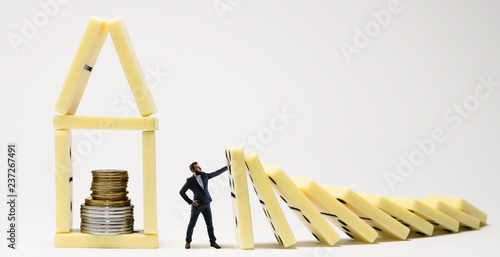 The man stops the fall of dominoes. Metaphor of crisis management. photo
