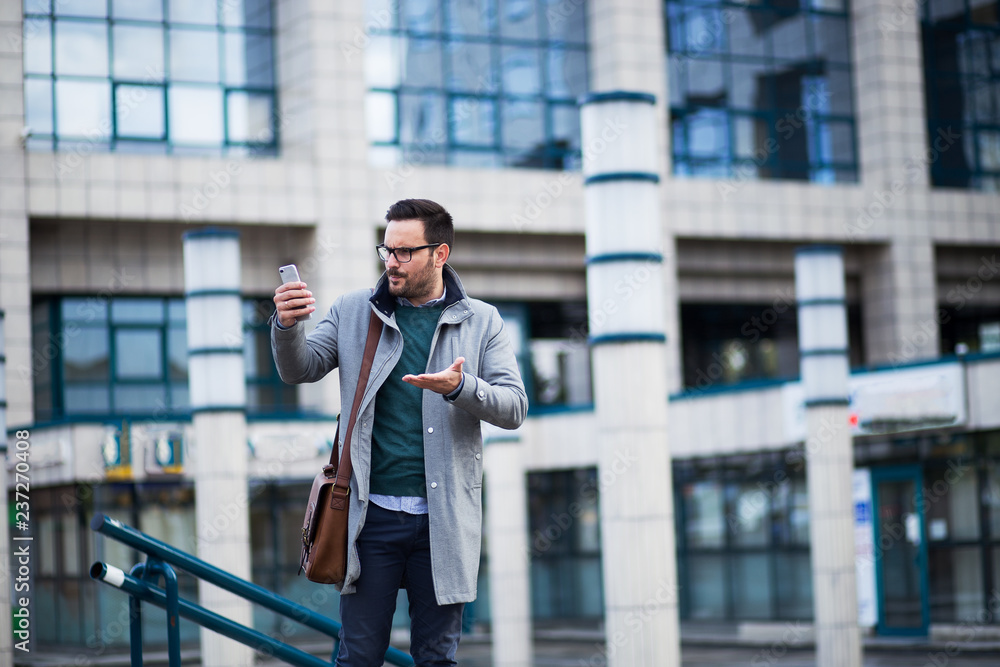 Frustrated businessman yelling at phone Frustrated businessman yelling at phone