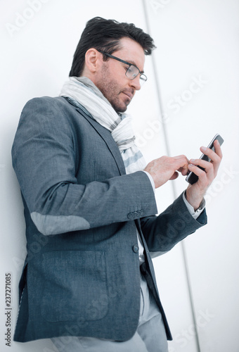 serious business man typing SMS on smartphone