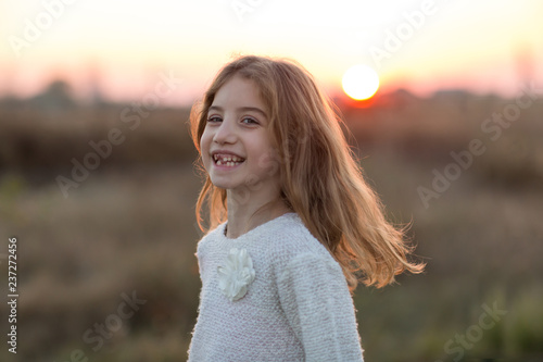 Portrait of adorable smiling little girl child outdoors
