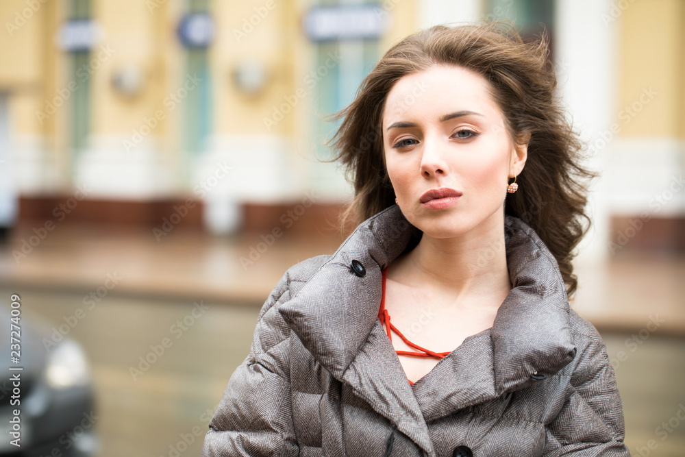 Closeup portrait of a young woman in the winter down jacket Closeup portrait of a young woman in the winter down jacket