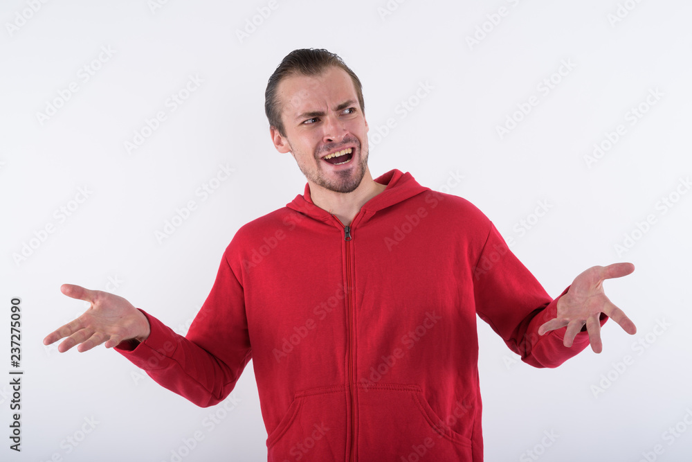Studio shot of young happy bearded man looking confused while th Studio shot of young happy bearded man looking confused while th
