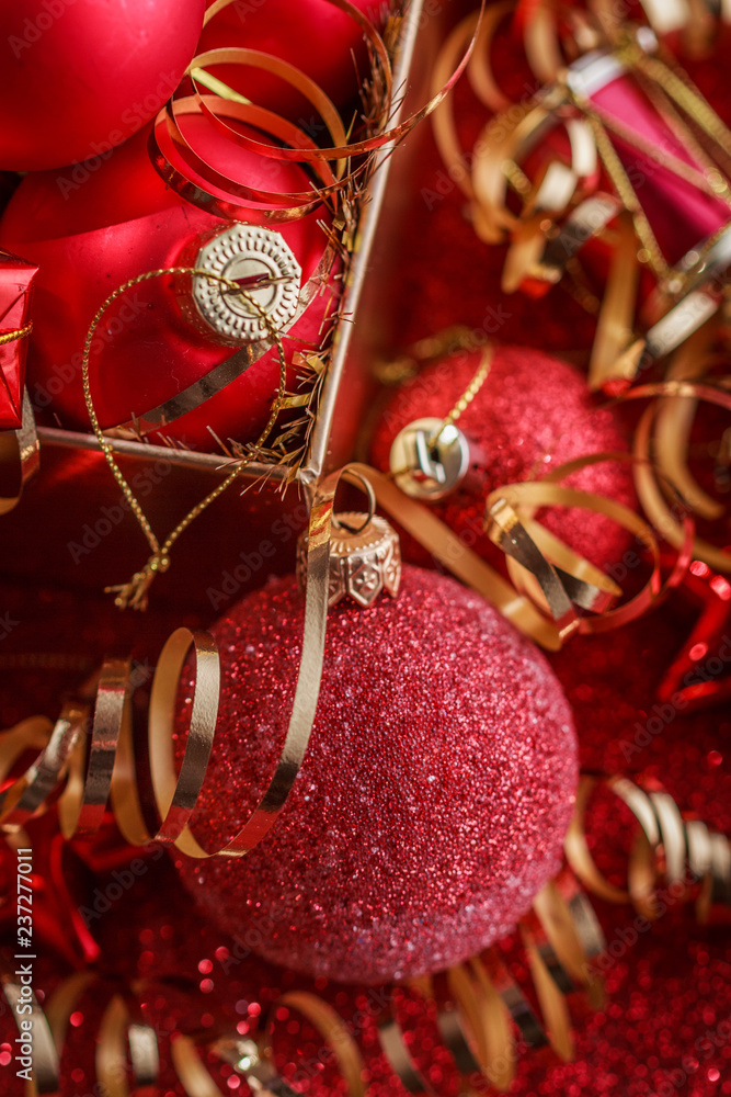 Christmas composition of Christmas tree toys on a blurred red background