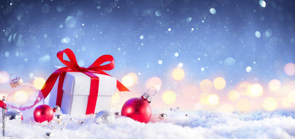 Christmas GiftBox With Bow On Snow
