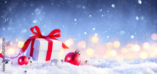 Christmas GiftBox With Bow On Snow 