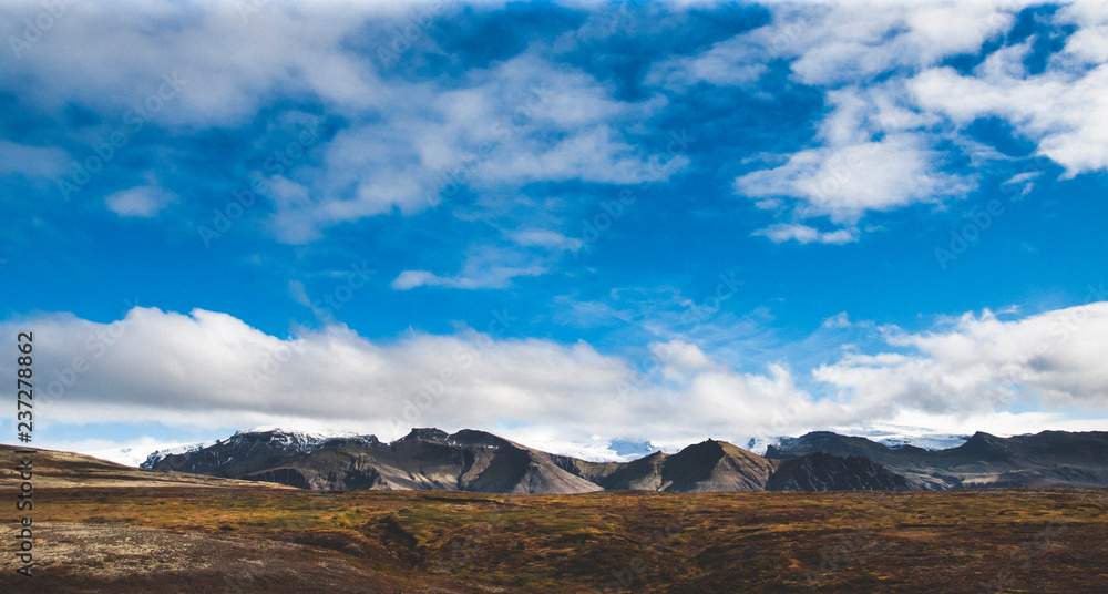 Beautiful and colorful blue skies with clouds and mountains in the background. Beautiful and colorful blue skies with clouds and mountains in the background.