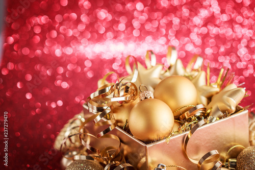 Christmas composition of Christmas tree toys on a blurred red background