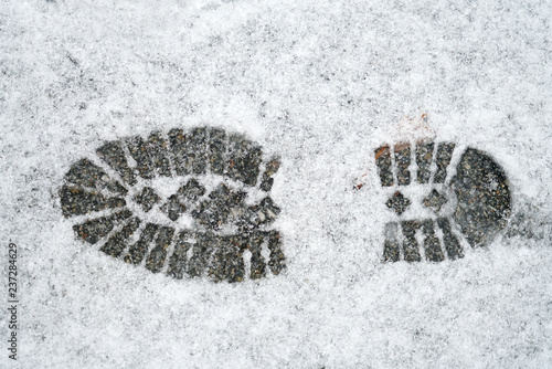 single boot footprint on the white snow