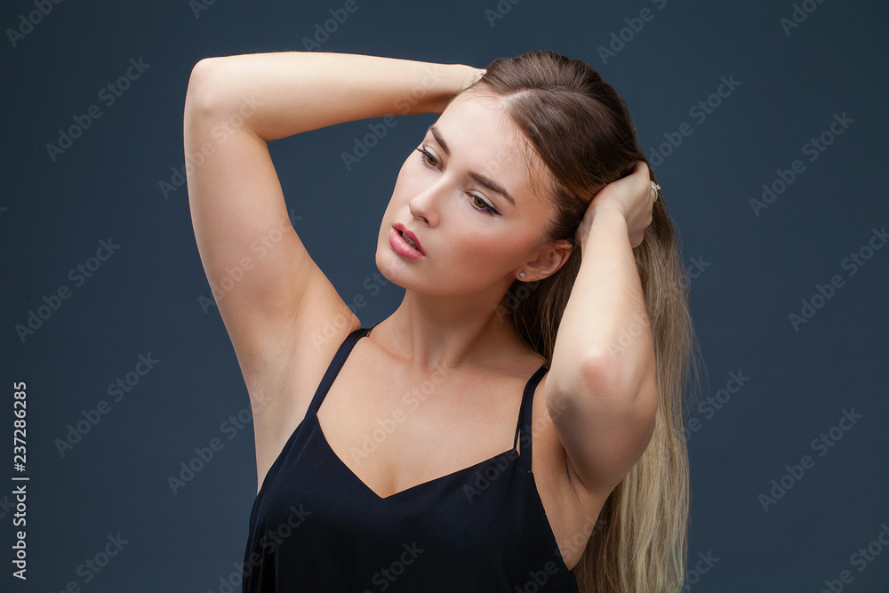 Fototapeta premium Beautiful blonde woman in black dress