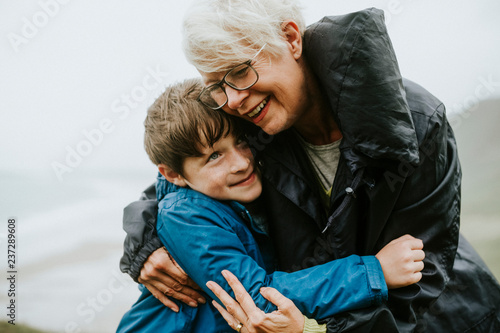 Happy grandmother hugging her grandson