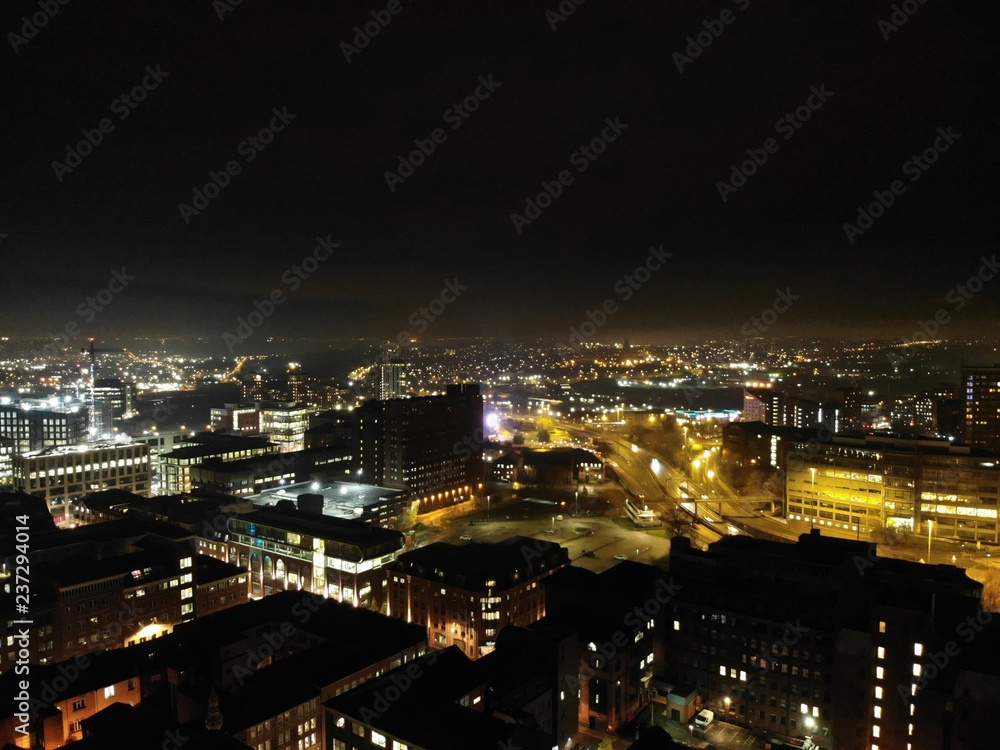 Aerial night time photo taken above the Leeds City Center at Christmas Time showing the Leeds Town Hall and buildings and roads around West Yorkshire.