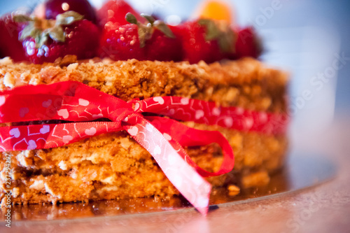 Delicious tart with fresh strawberries, raspberries and currants on the table.