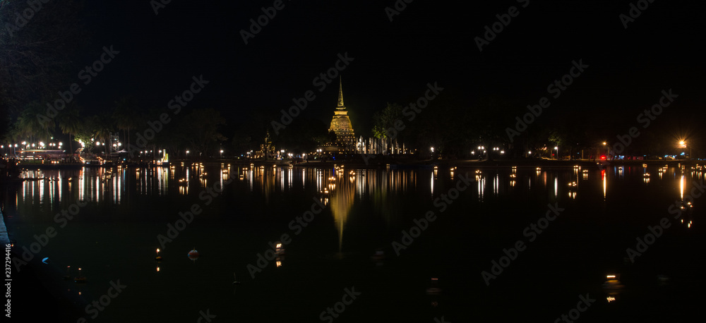  Sukhothai historical park  at night with lighting in Loy Krathong Festival .  Sukhothai, Thailand