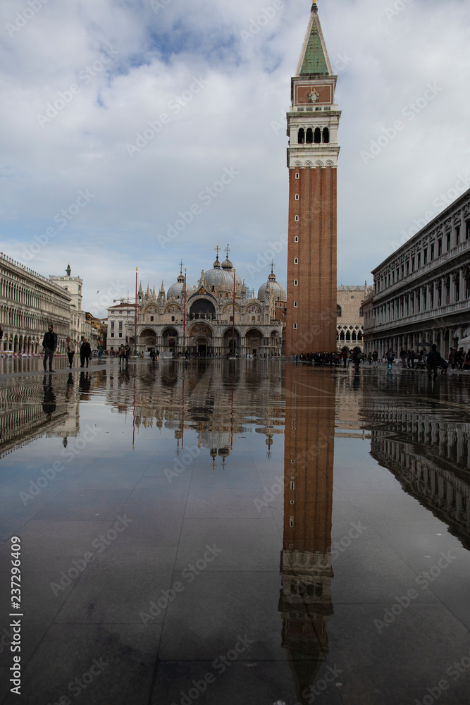 Venice, Italy - November 27, 2018: High water on St. Mark's Square in Venice. St. Marks Square (Piazza San Marco) during flood (acqua alta) in Venice, Italy. St. Mark's Basilica