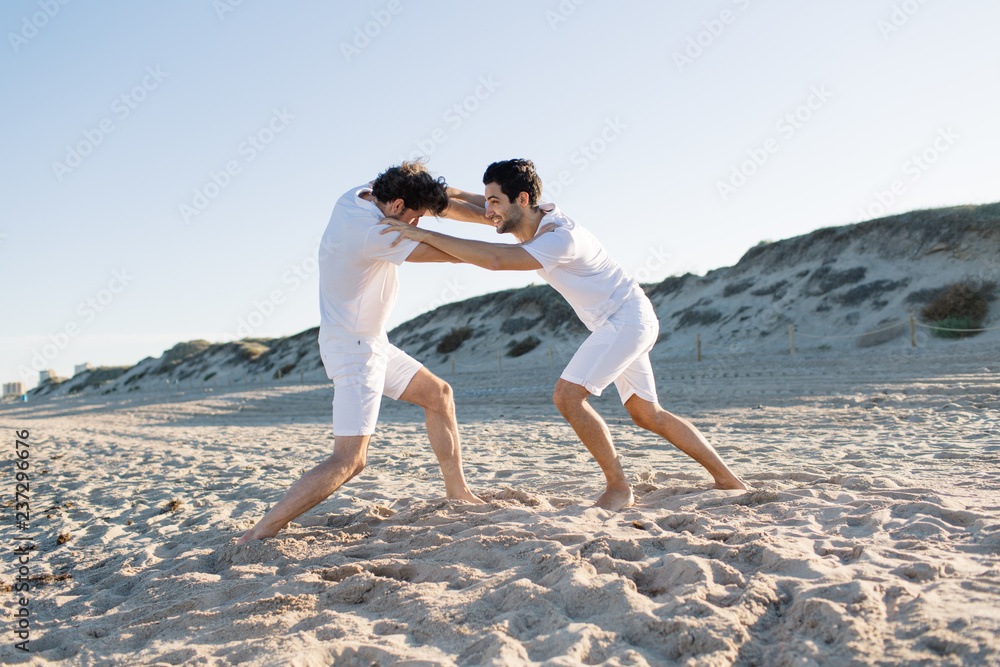 Men fighting on beach Men fighting on beach