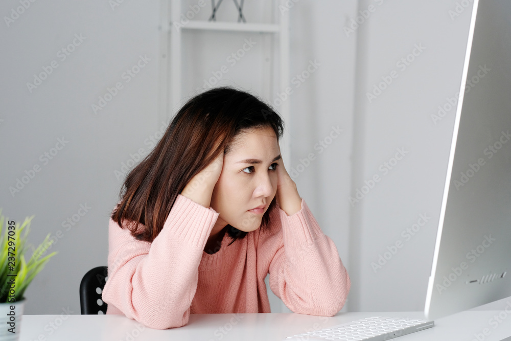 Young asian woman with frustrated expression while working with computer, working from home, casual office lifestyle Young asian woman with frustrated expression while working with computer, working from home, casual office lifestyle