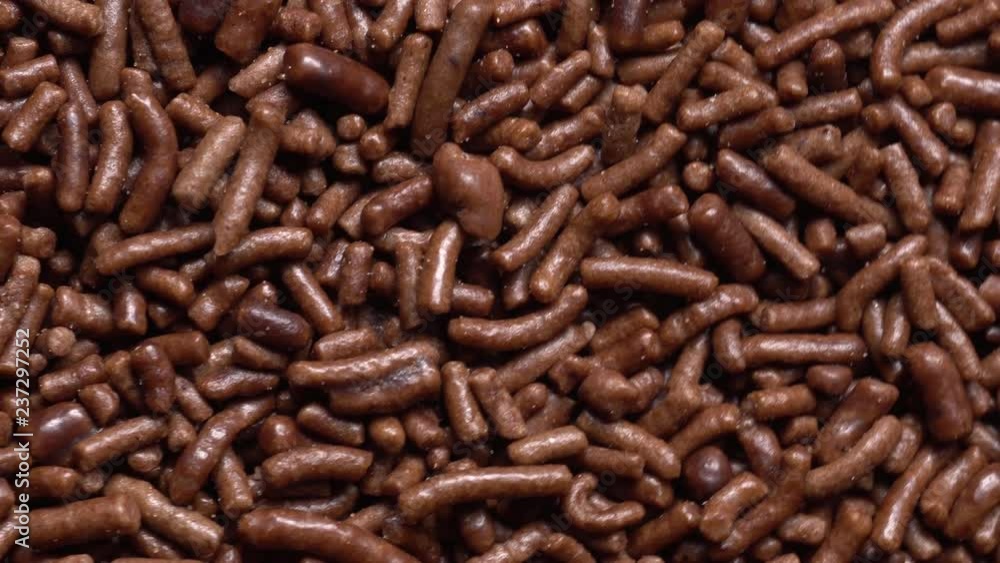 Chocolate crumbs in rotation. Closeup. Chocolate crumbs in rotation. Closeup.