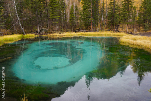 Beautiful Geyser Lake with blue clay in autumn, Altai,Russia.