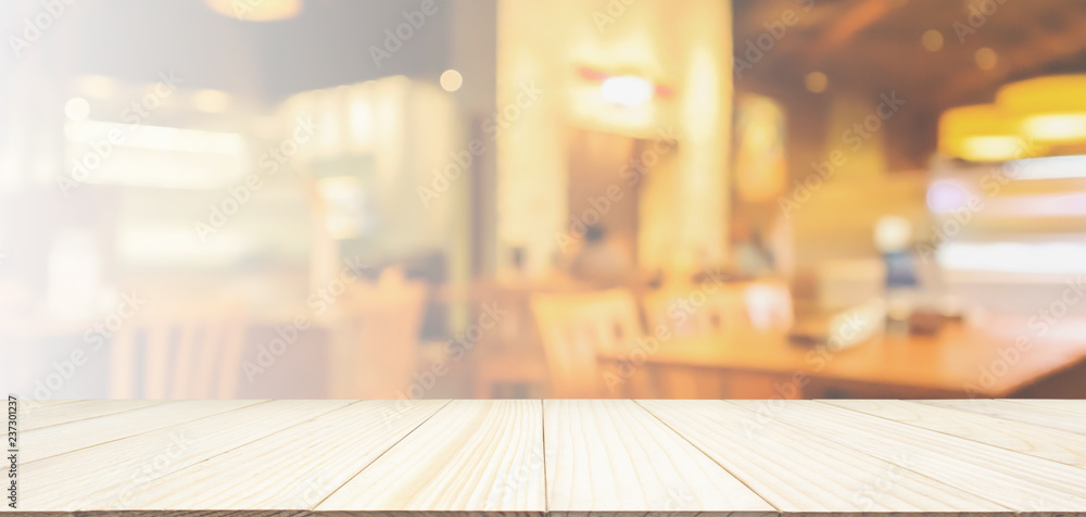 Wood table top with Restaurant cafe or coffee shop interior with people abstract defocused blur background Wood table top with Restaurant cafe or coffee shop interior with people abstract defocused blur background