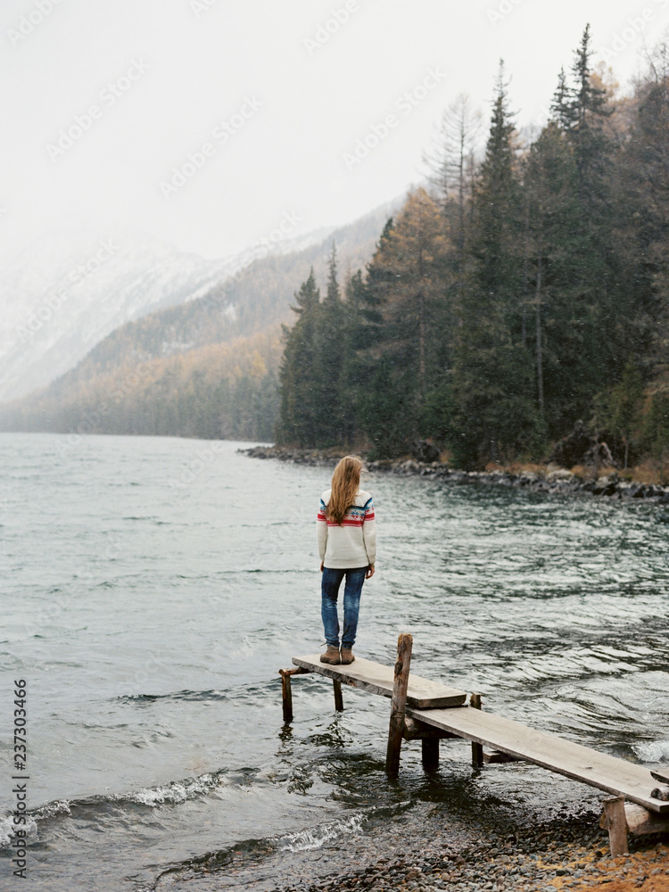 Person on shore of lake