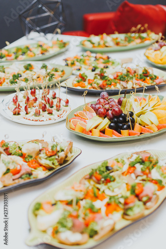 lots of different food at a party ,close up, sandwiches and fruits
