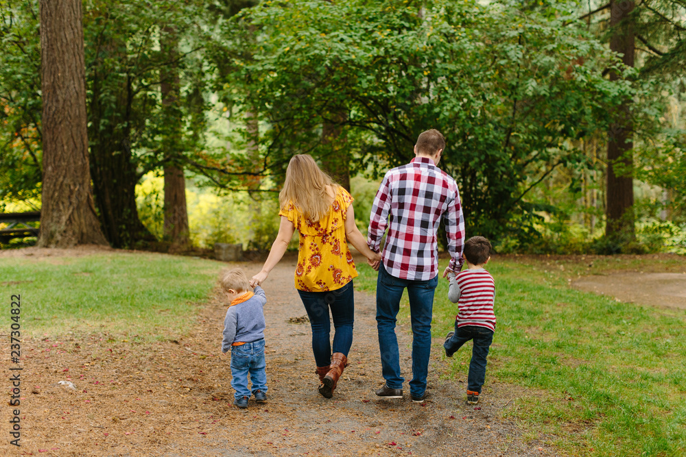 Cute, Fun Family Walking in Park Cute, Fun Family Walking in Park