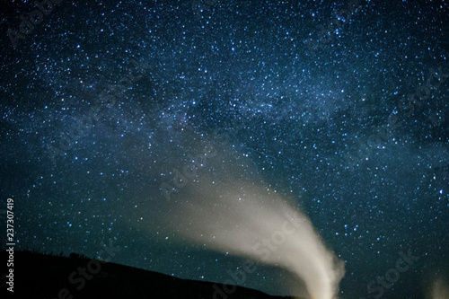 The Milky Way rising over Old Faithful erupting in Yellowstone National Park  Wyoming 