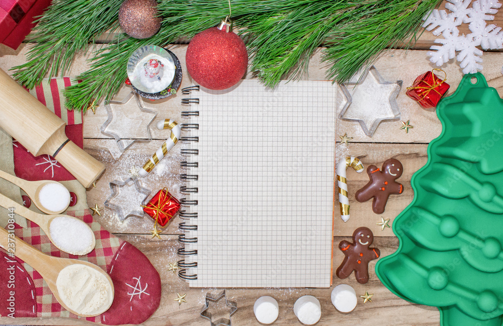 Christmas baking cake background. Ingredients and tools for baking - flour,  eggs, silicone molds in the shape of a Christmas tree, and a rolling pin on  a wooden background. Stock Photo