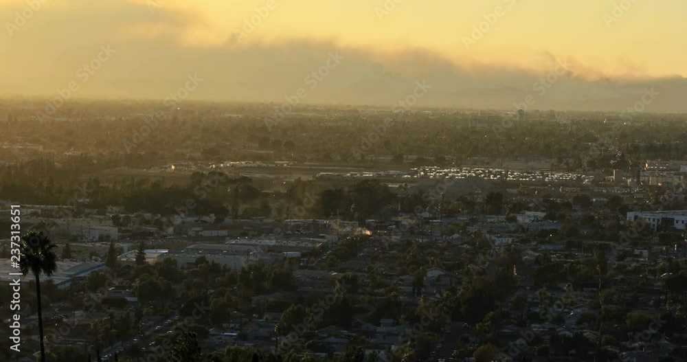 Smoke from wildfires behind city at sunset - time lapse Smoke from wildfires behind city at sunset - time lapse