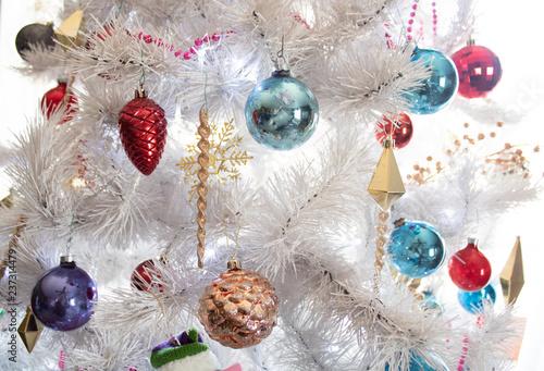 vintage white artificial christmas tree with glittery ornaments