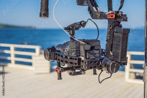 profeccional cinema camera on a 3-axis camera stabilizer system on a commercial production set photo