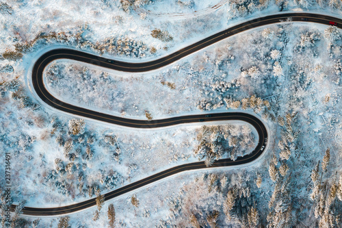 Aerial view on Serpentine in snowy winter forest. Winding road in frosty forest. © dzmitrock87