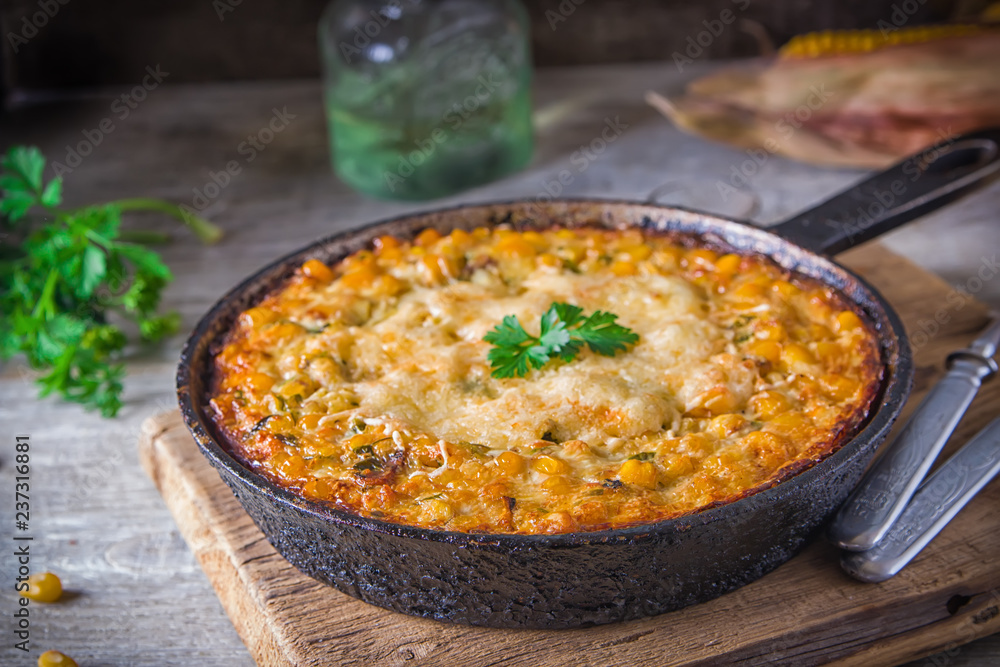 Traditional corn casserole with cheese. Below the corn - parsley mix is ground cheese, olive, egg, baked onion, garlic