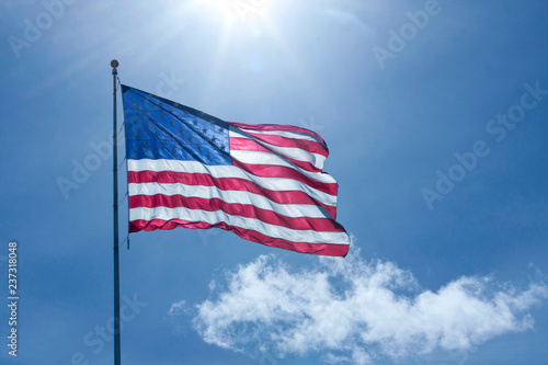 American flag is backlit by the afternoon sun 