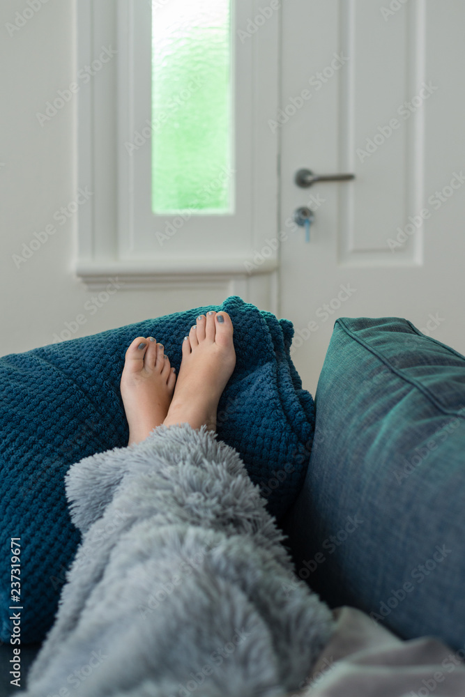 young woman's feet on sofa Stock Photo Adobe Stock
