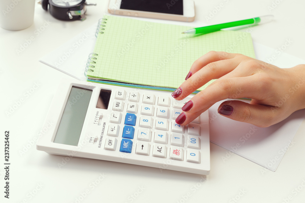 Business woman working with financial data hand using calculator Business woman working with financial data hand using calculator